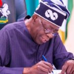 image of Tinubu writing
