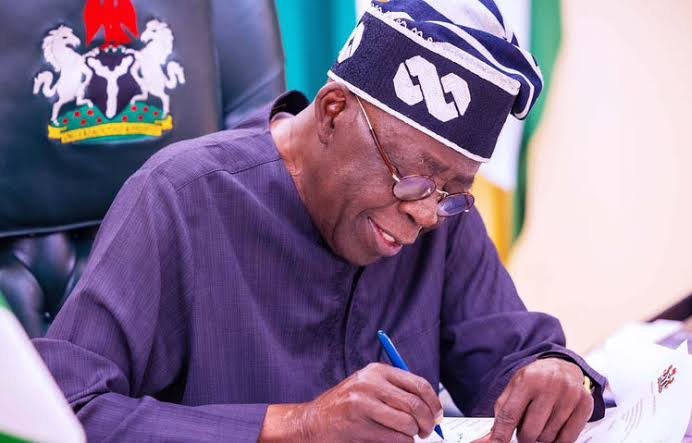 image of Tinubu writing